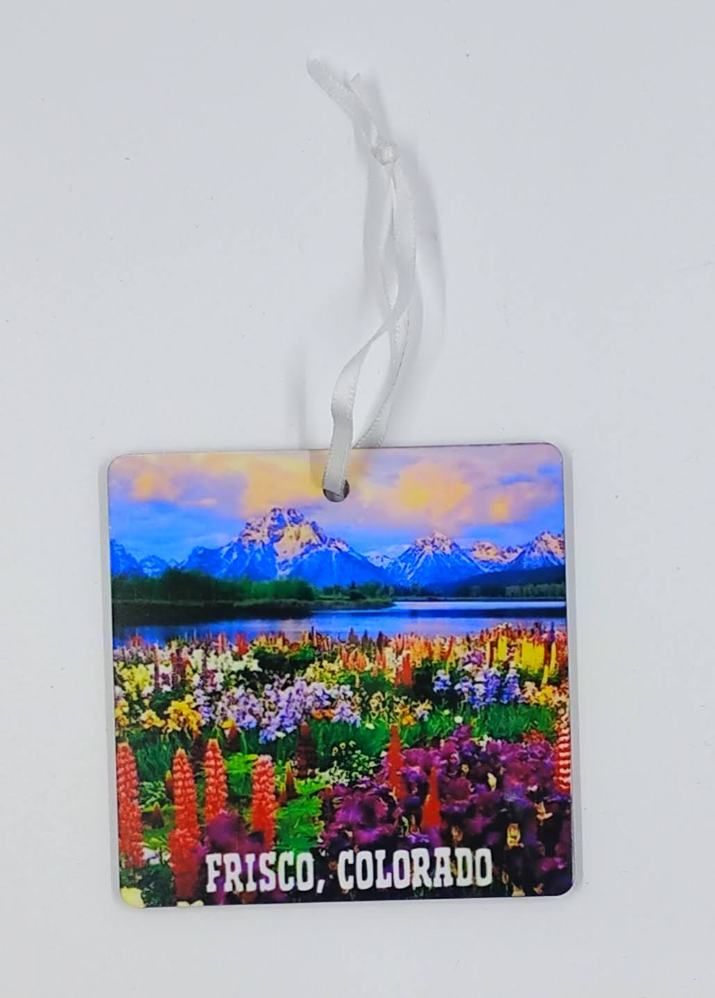 Square Christmas Ornament with a colorful field of flowers and mountains and a lake in the background