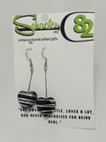 Handcrafted black heart dangle earrings with white swirl  accents