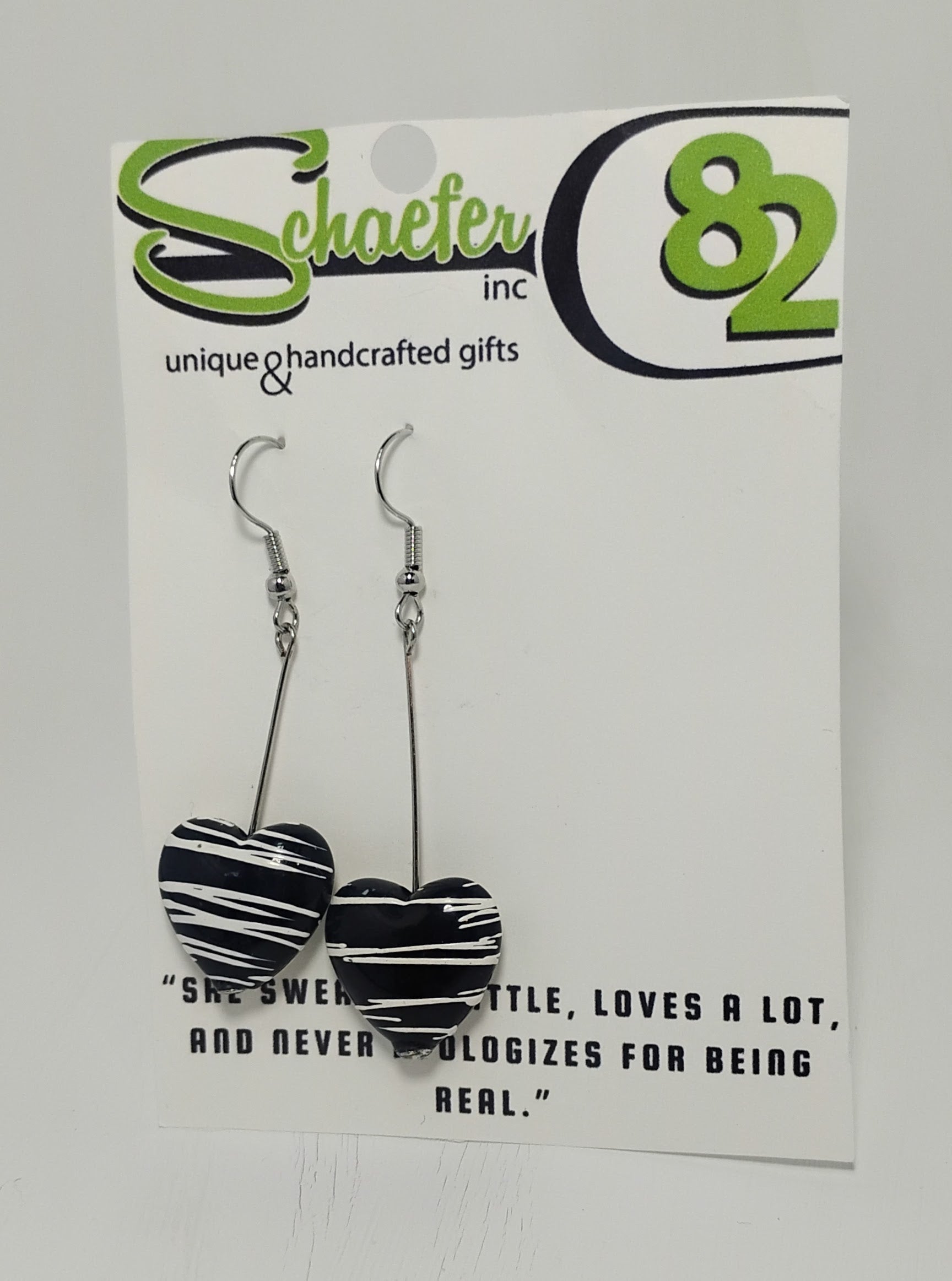 Handcrafted black heart dangle earrings with white swirl  accents