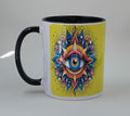 With a yellow background, the colorful evil eye appears to popping off the coffee mug