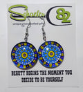 Handcrafted blue and yellow mandala disc earrings with a swirl pattern. 