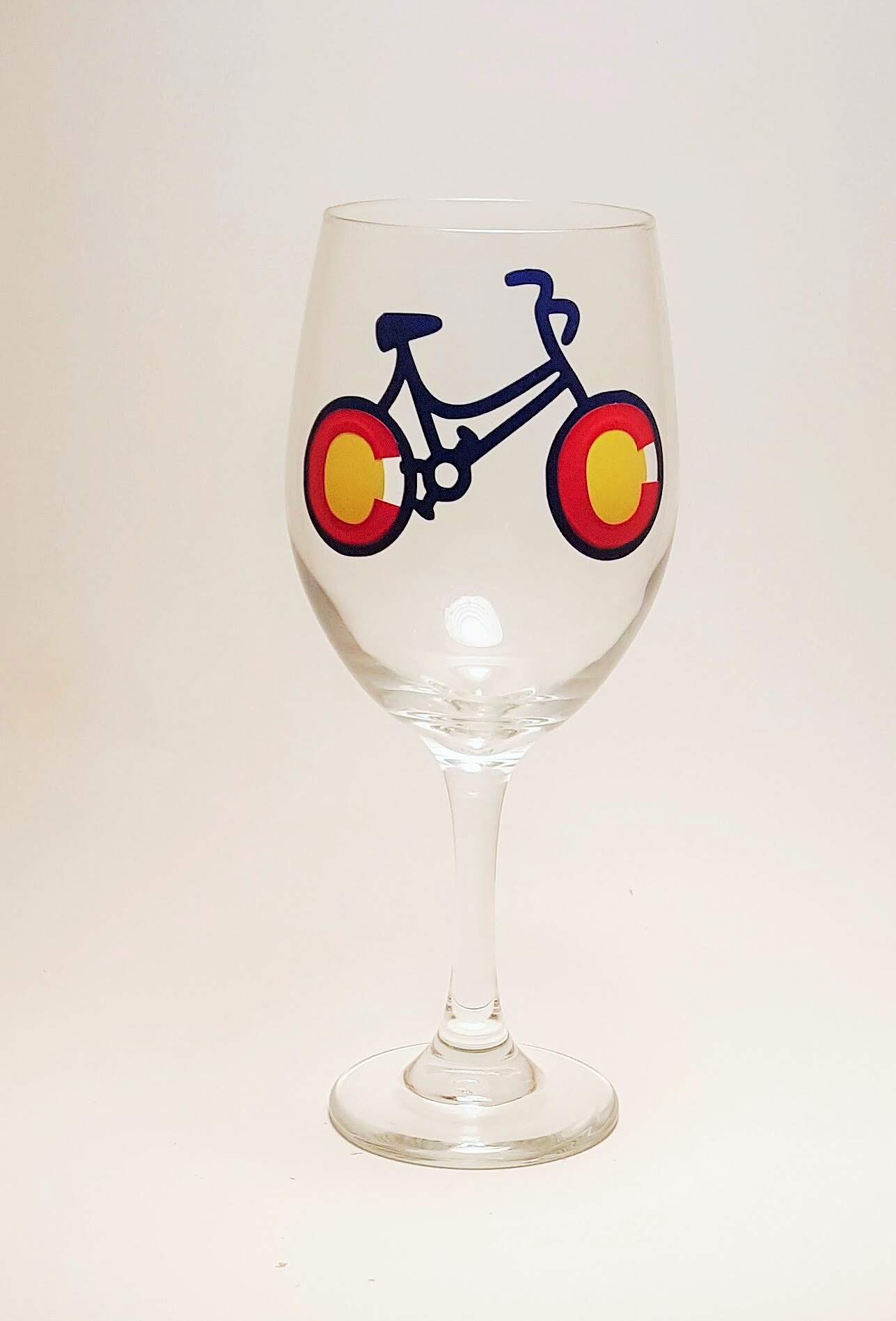 Handcrafted wine glass with a bike design, made to resemble the Colorado flag.