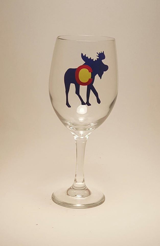 Handcrafted wine glass with a moose design, which is made to resemble the Colorado flag.