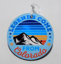 Light blue Christmas ornament that has a mountain scenery and the saying "legends come from Colorado".