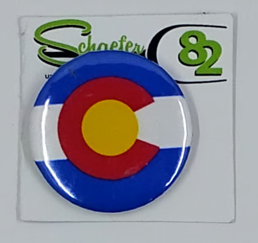 Small circular hat pin with the image of the colorado flag. 