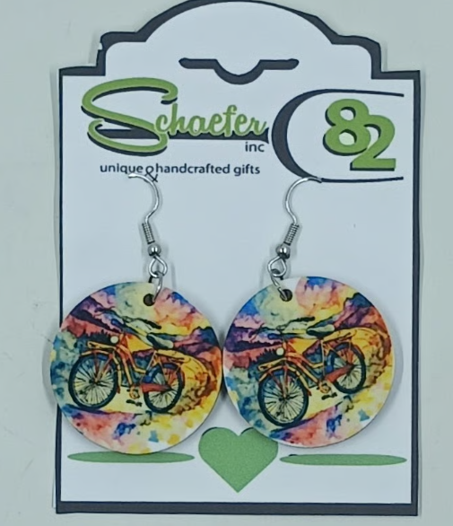Small round circle earrings with the image of a bike in front of a very colorful background