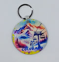 Handcrafted colorful mountain and chairlift keychain.