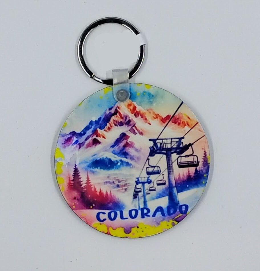Handcrafted colorful mountain and chairlift keychain.