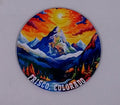 Beautiful round coaster with a bright sunset and mountains