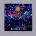 Handcrafted colorful coaster with a mountain scene, moon, and stars in the sky. 
