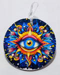 Handcrafted circular evil eye ornament with a bright colored background. 