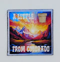 Colorful square magnet with an image of the mountains and a river and a gorgeous sunrise and the saying "A little pot from Colorado"