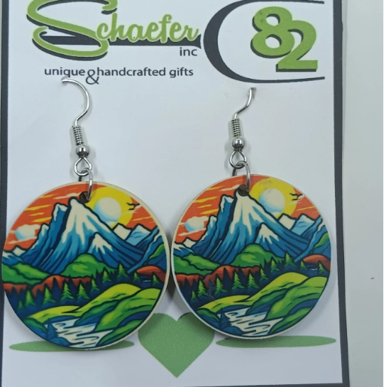 Handcrafted colorful mountain landscape with a green field, river flowing, and an orange sky. 