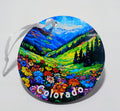 Circular ornament with a beautiful valley of flowers and mountains. 