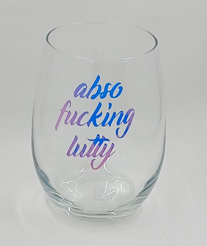 Funny stemless wine glass with the saying "abso-f*cking-lutly" in colorful letters