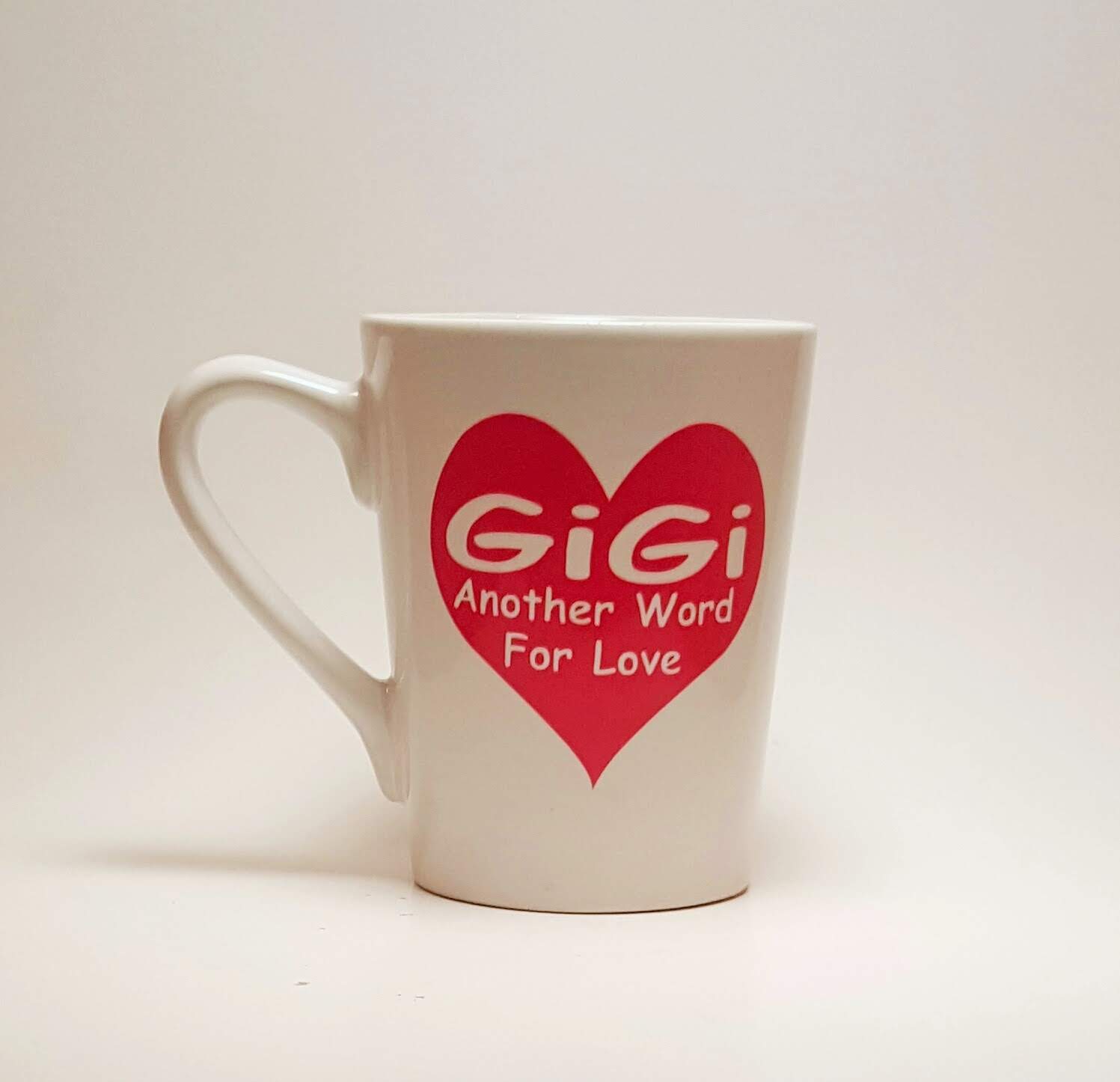 Handcrafted coffee mug with a large heart and the quote "Gigi, another word for love". 