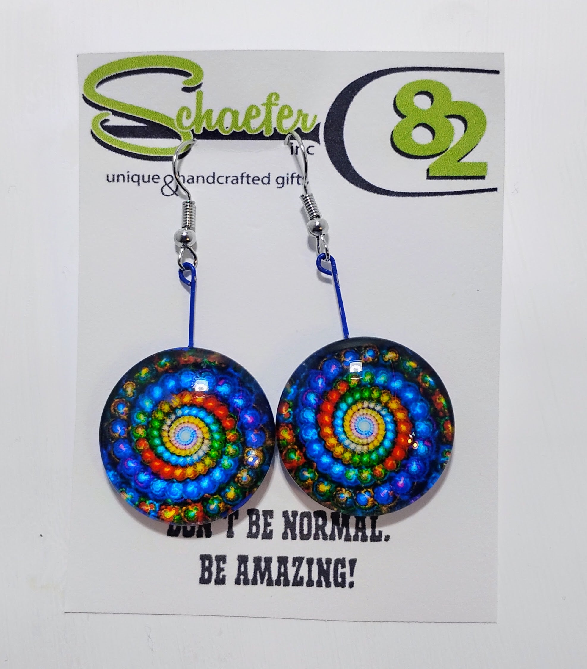 Handcrafted earrings that are large discs with very bright colors creating a swirl. They are hypnotic. 