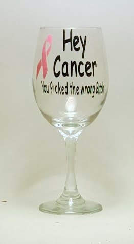 Handcrafted wine glass with the saying "Hey cancer, you picked the wrong *itch" and a pink ribon. 