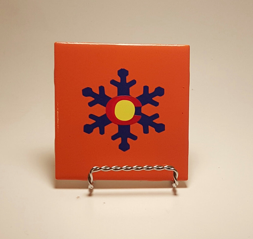 Handcrafted orange coaster with a snowflake design that actually makes the Colorado flag