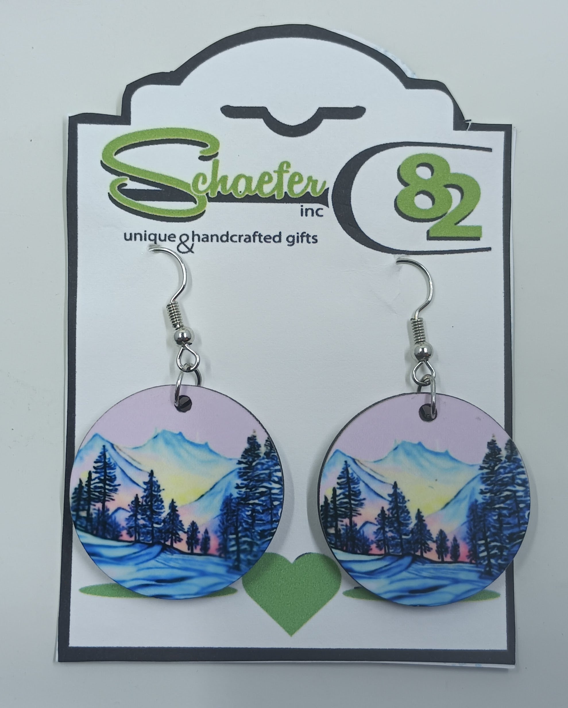 Handcrafted circular earrings with a purple sky and a beautiful snowy mountain scenery. 