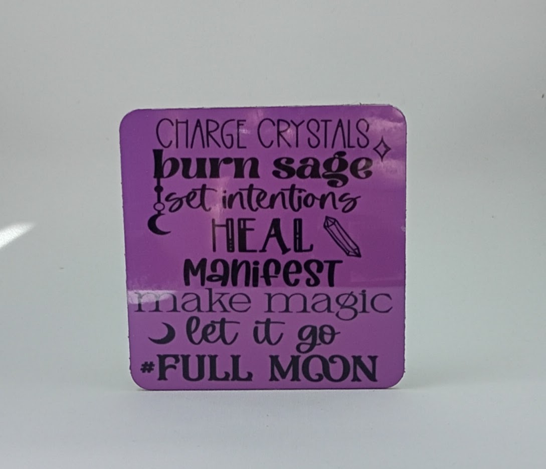 Handcrafted purple square coaster with the saying "Charge crystals, burn sage, set intentions, heal, manifest, make magic, let it go, full moon"