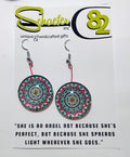Handcrafted Radiant bloom mandala earrings, with bright greens, red, and yellows. 