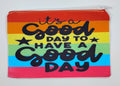 Handcrafted rainbow zipper bag which has the quote "It's a good day to have a goody day" in black. 