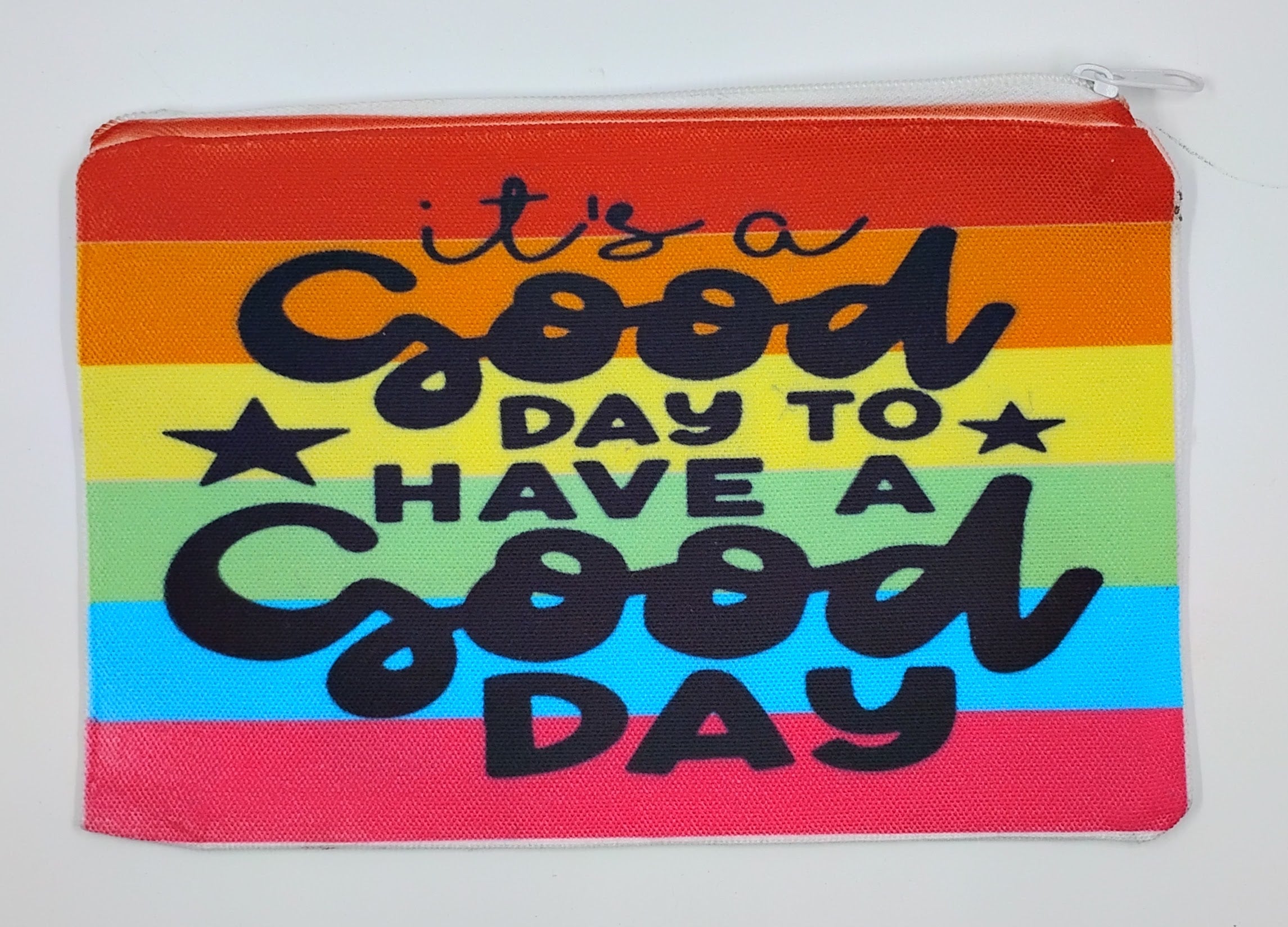 Handcrafted rainbow zipper bag which has the quote "It's a good day to have a goody day" in black. 