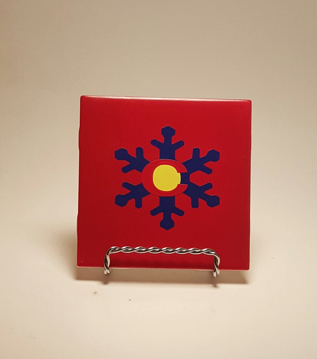 Handcrafted red coaster with a Colorado flag design made out of a snowflake. 