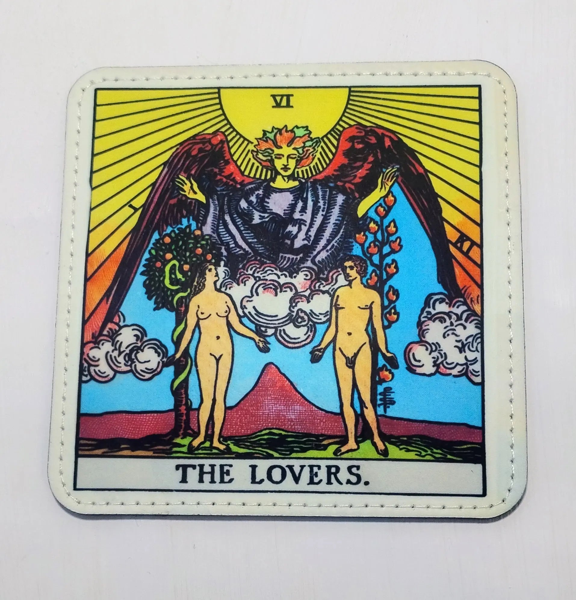 Handcrafted white pleather coaster with the tarot card image for the lovers, which is a couple, standing in front of an angel.