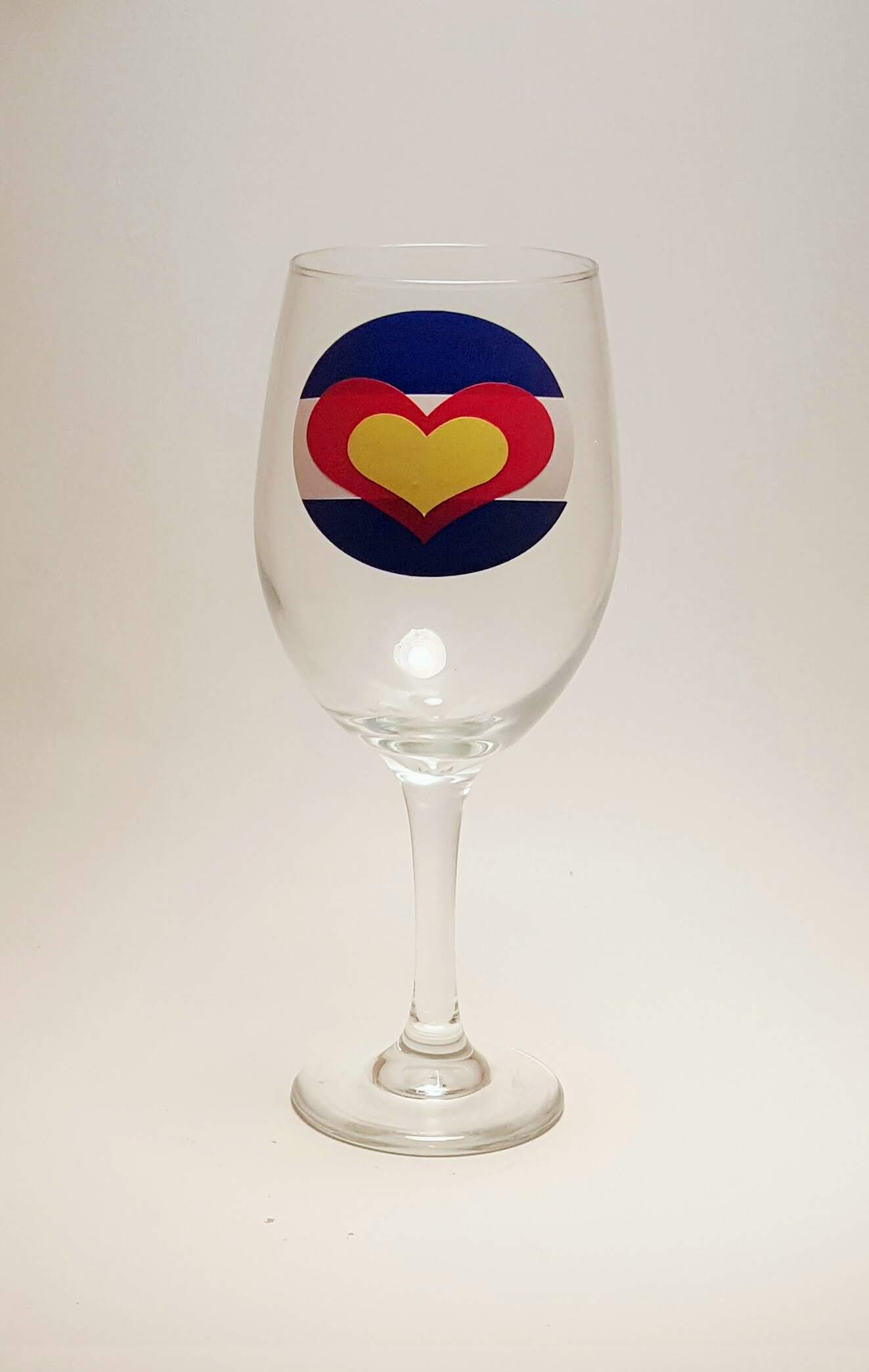 Handcrafted wine glass that has the Colorado flag, made out of hearts. 