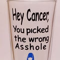 Standard beer glass with the handcrafted unique design that says "Hey cancer, you picked the wrong *sshole" and has a blue ribon