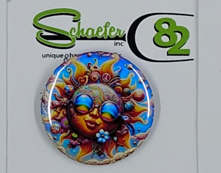 Small circular hat pin with a very colorful hippy looking sun wearing rainbow glasses