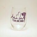 A stemless wine glass with a heart beat image and the words "live, love,nurse".