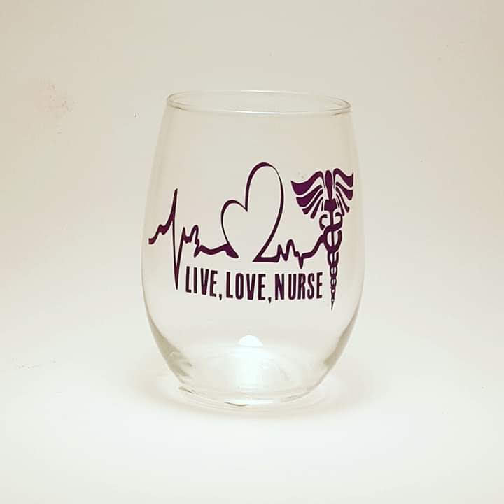 A stemless wine glass with a heart beat image and the words "live, love,nurse".