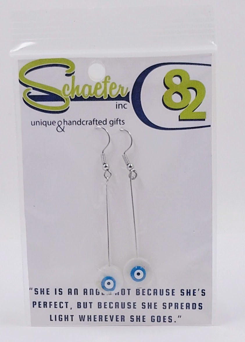 Handcrafted Evil eye earrings, which have the eyes on white shells. 