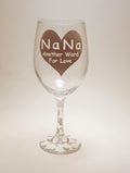 Handcrafted wine glass with a large heart design and the quote "Nana, another word for love" and it's covered in polka dots.