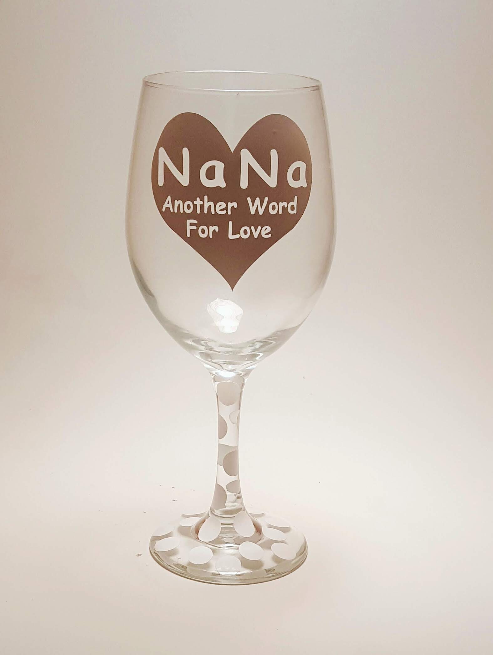 Handcrafted wine glass with a large heart design and the quote "Nana, another word for love" and it's covered in polka dots.