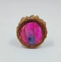Handcrafted pendant from real pinecones and a bright pink glowing center with a pink and purple dyed clear quartz in the center