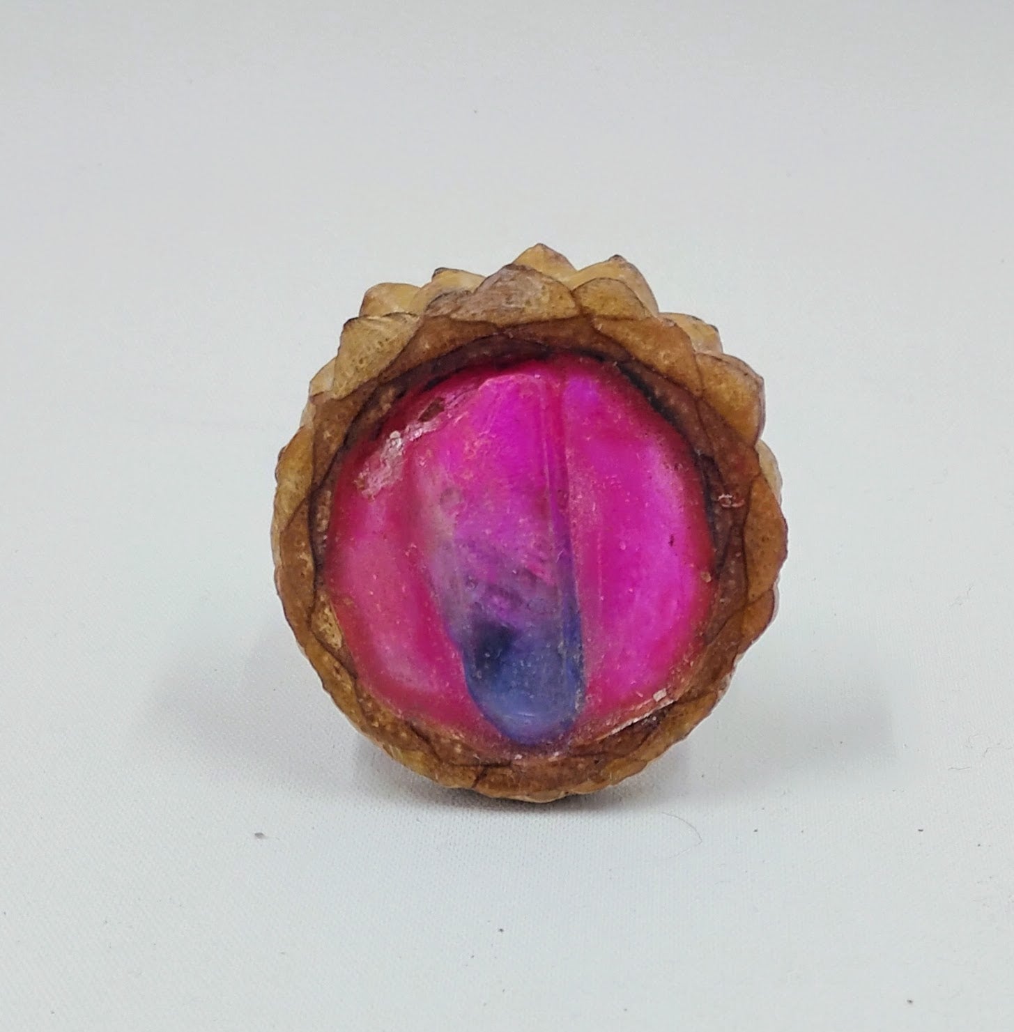 Handcrafted pendant from real pinecones and a bright pink glowing center with a pink and purple dyed clear quartz in the center