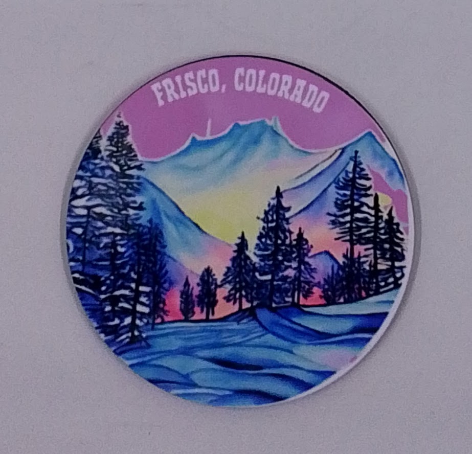 Beautiful round handcrafted coaster with a purple sky and beautiful mountains, all covered in snow.