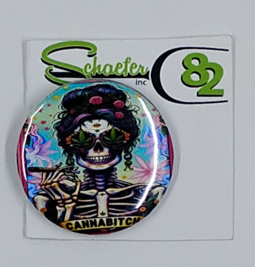 Small circular hat pin with the image of a colorful skeleton smoking a joint while wearing weed glasses and the bottom some canna*itch