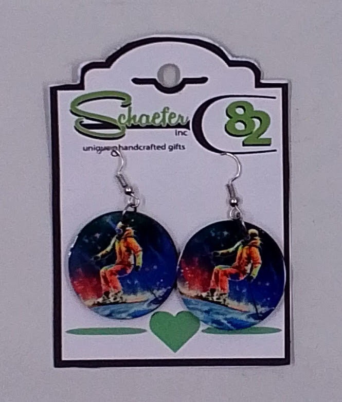 Small circular dangle earrings with a colorful image of a skier going down the mountain.