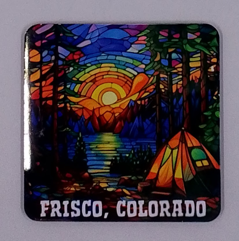 Colorful handcrafted Christmas ornament with a beautiful sunset and a lake with a tent in a beautiful forest.