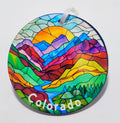 Colorful stained glass inspired ornament with a beautiful mountain scenery and river.