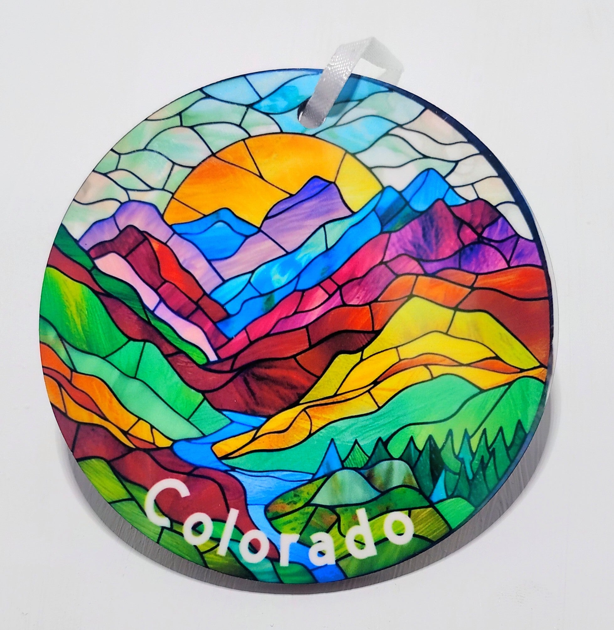 Colorful stained glass inspired ornament with a beautiful mountain scenery and river.