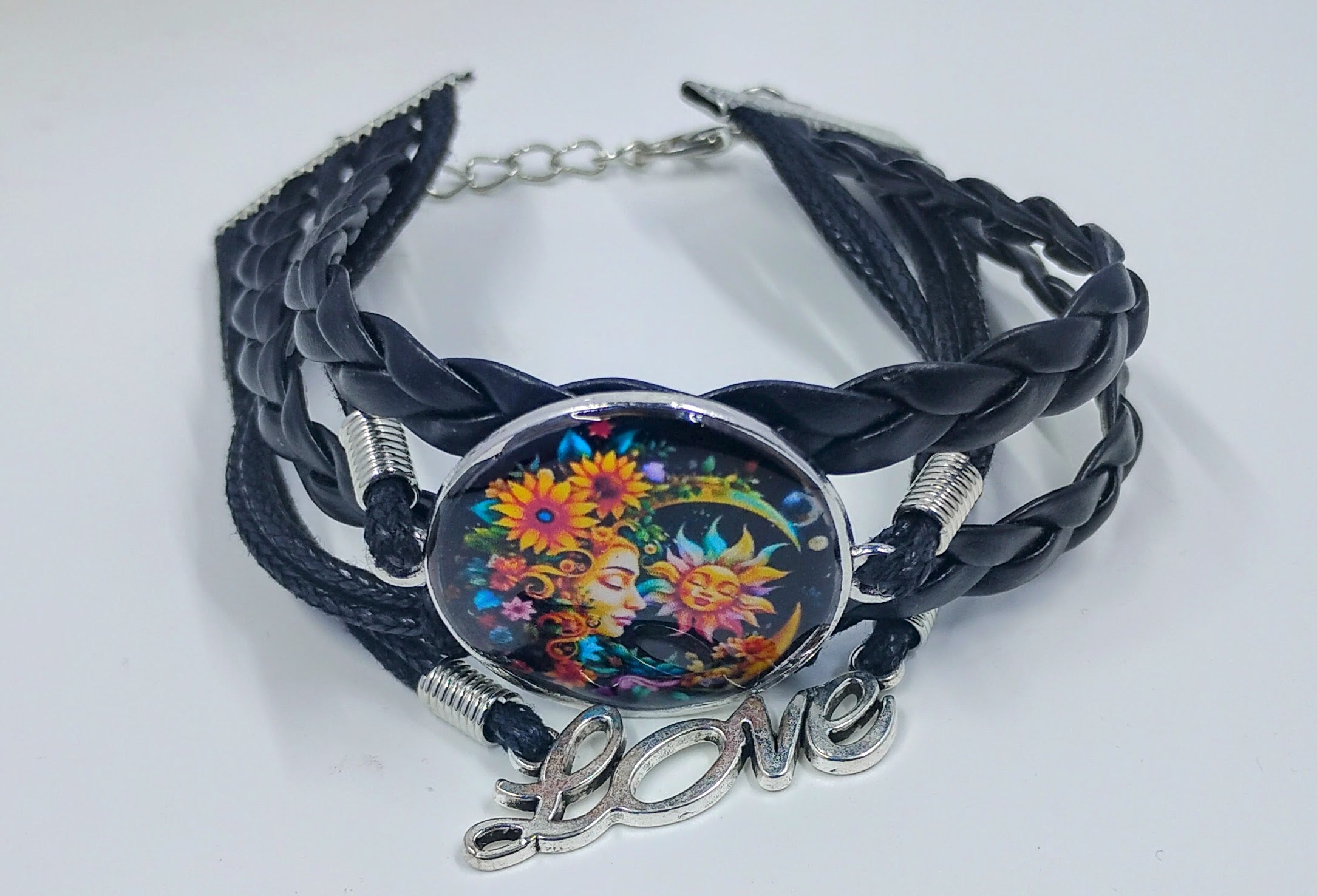 Handcrafted black leather bracelet with a colorful moon and the word love. Very celestial style jewelry.
