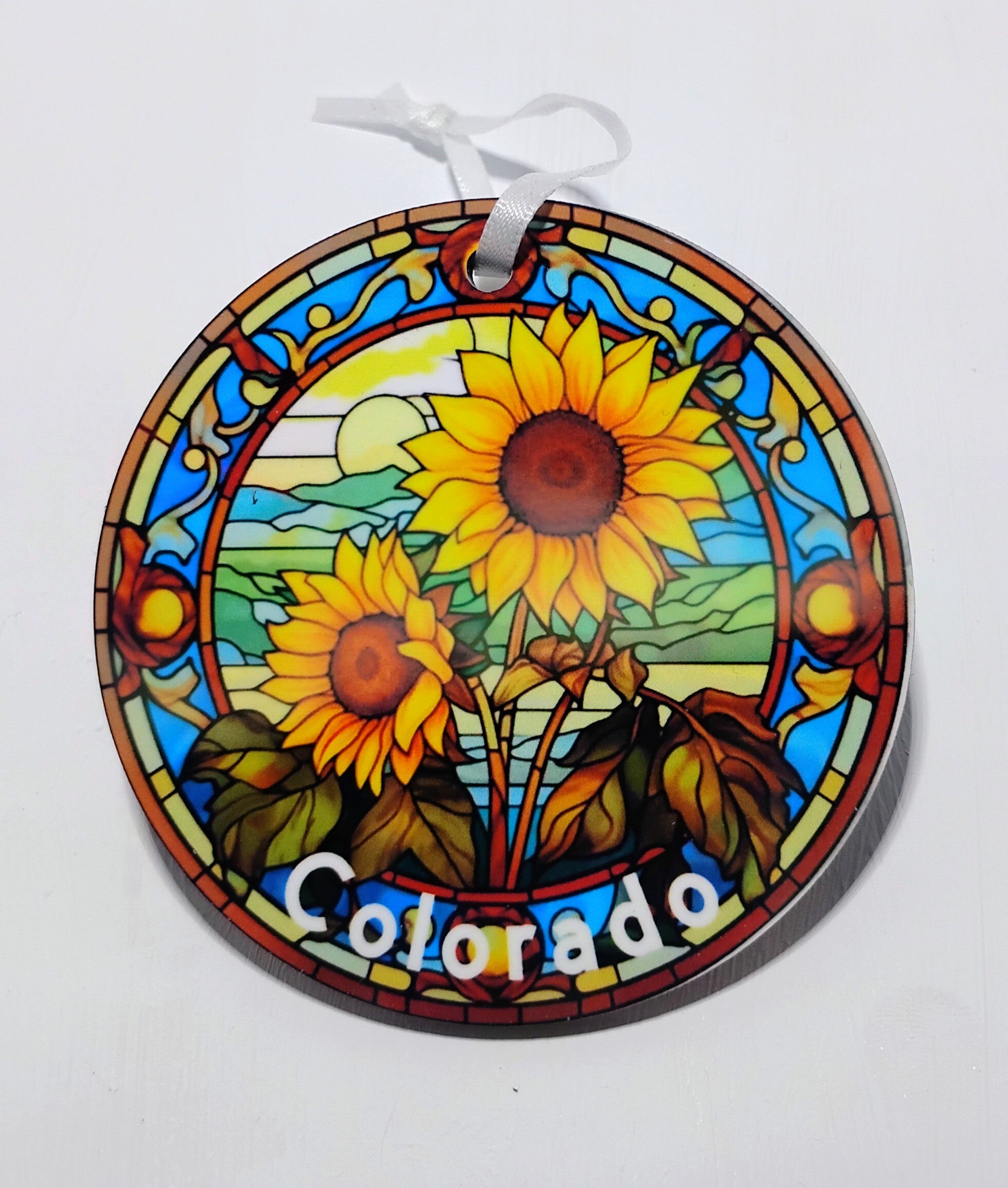 Handcrafted Christmas ornament with an image of sunflowers and a bright sun! 