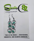 Pair of silver hoop earrings that have teal accents throughout. 