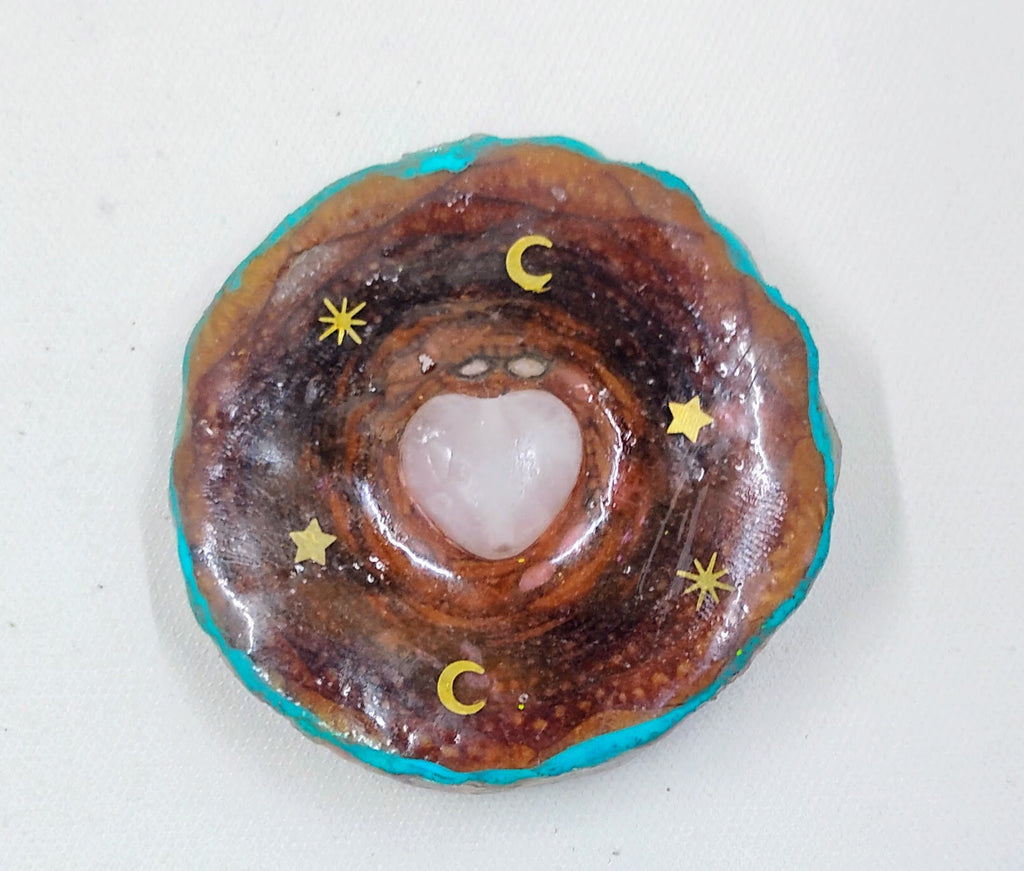 Handcrafted  third eye pinecone necklace with teal accents and gold moons and stars. 